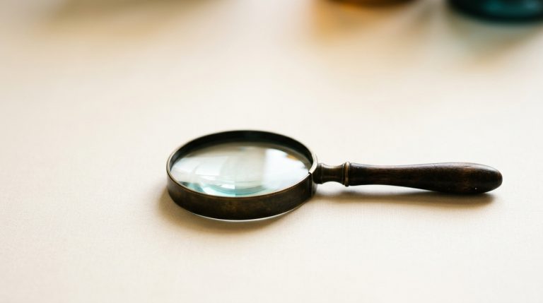 Magnifying glass on an ivory surface